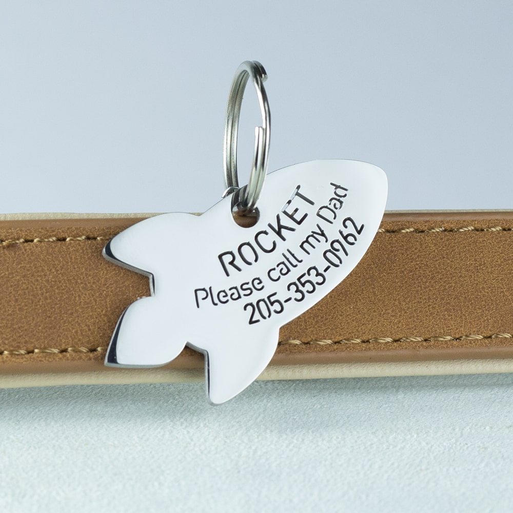 custom hollow laser-cut stainless steel rocket dog ID tag with cut-through name lettering
