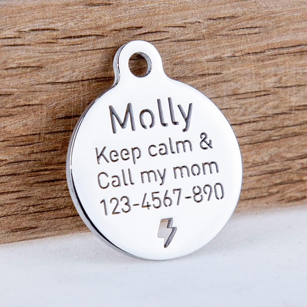 custom hollow laser-cut stainless steel small round dog ID tag with cut-through name lettering